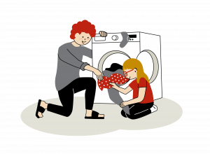 En vuxen och ett barn sitter framför en vit frontmatad tvättmaskin och plockar i tvätt. Illustration.